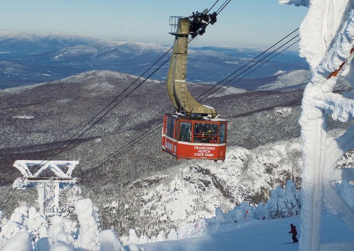 The Cannon Mountain aerial tram over snow-covered Franconia Notch