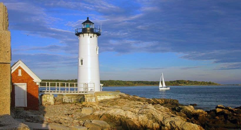 Portsmouth Harbor Lighthouse with a sailboat passing