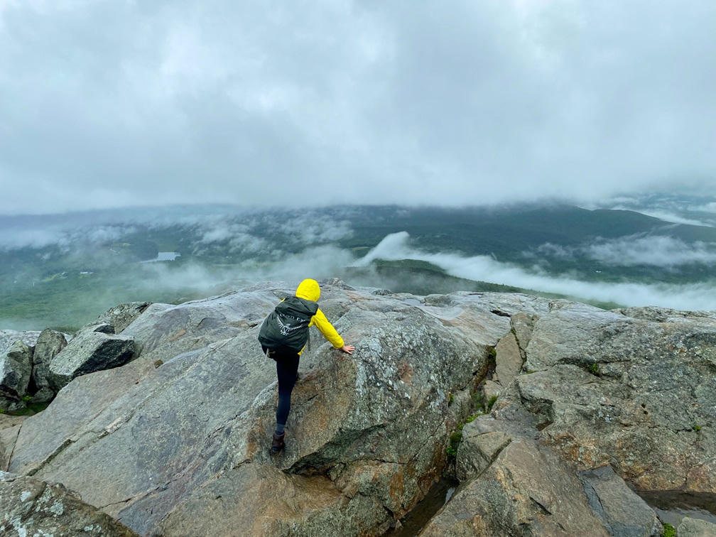 A hiker on the rocky summit of Mount Monadnock